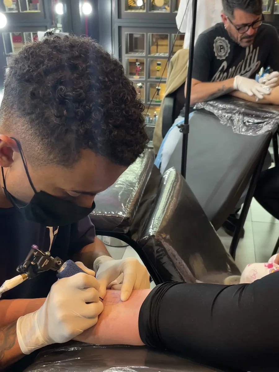 Sessão de tatuagem em andamento no estúdio